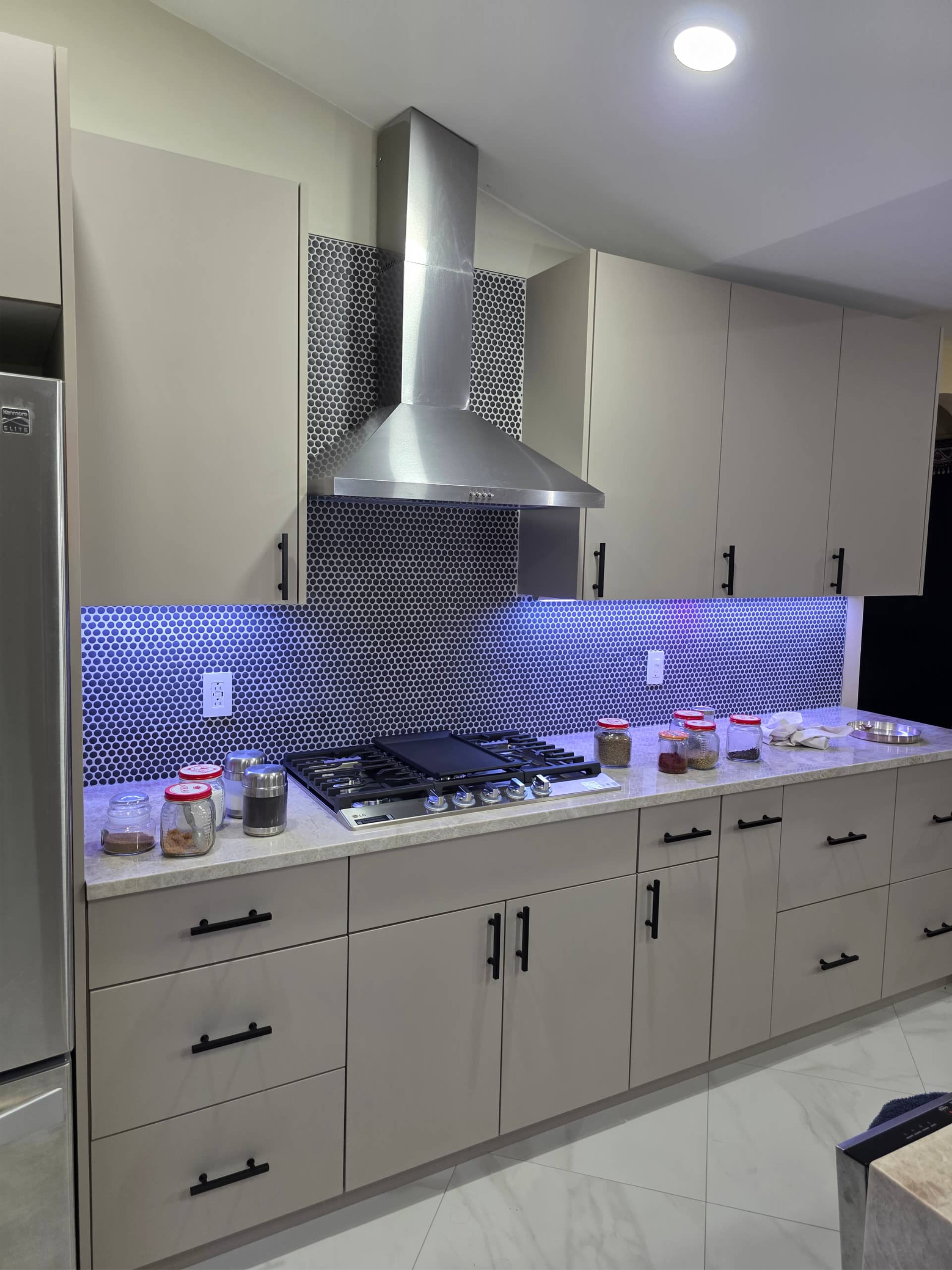 Devang custom kitchen cooking area with backsplash and hood